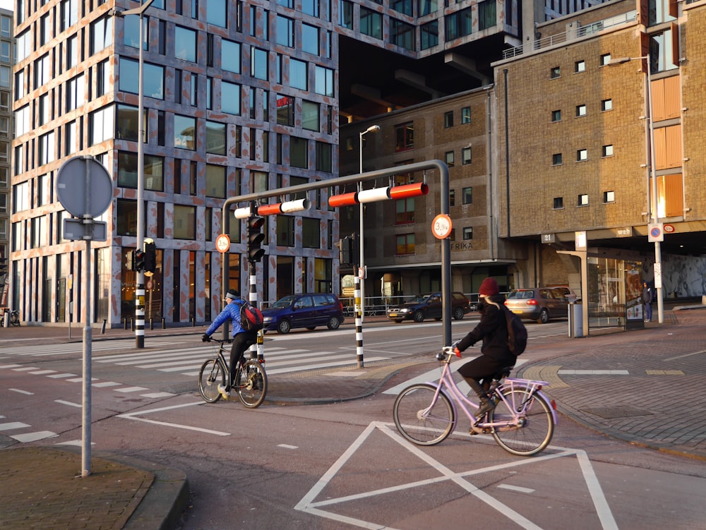 man in black jacket riding bicycle on road during daytime