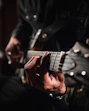 man playing guitar in close up photography