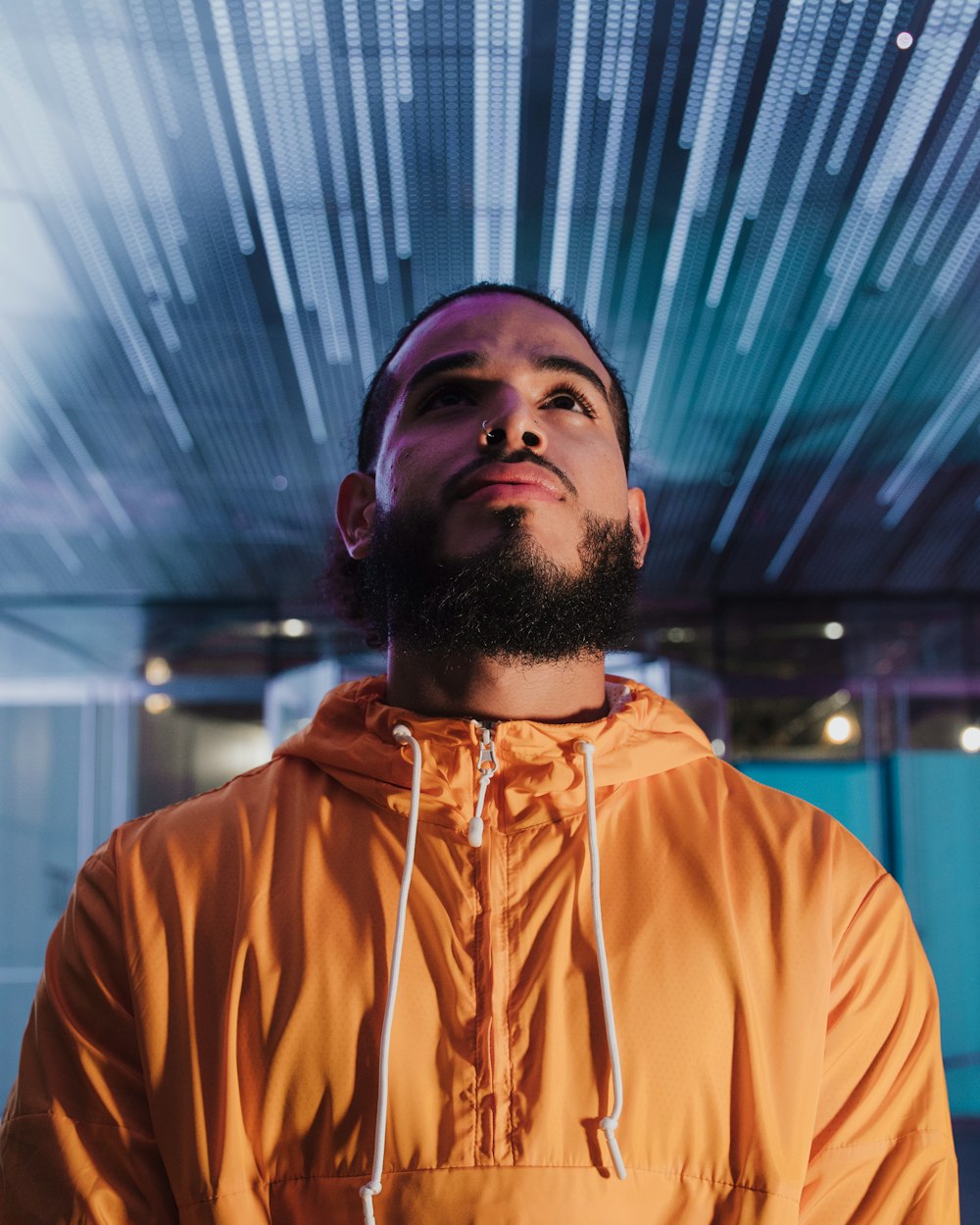 man in orange hoodie standing