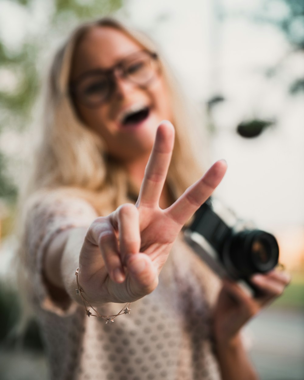 woman in white shirt holding camera