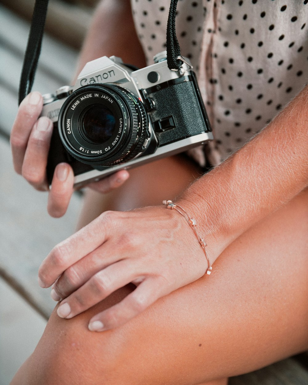woman holding black and silver camera