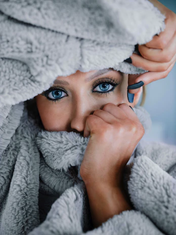 A young girl wrapped in a cozy blanket, eyes shining with gratitude.