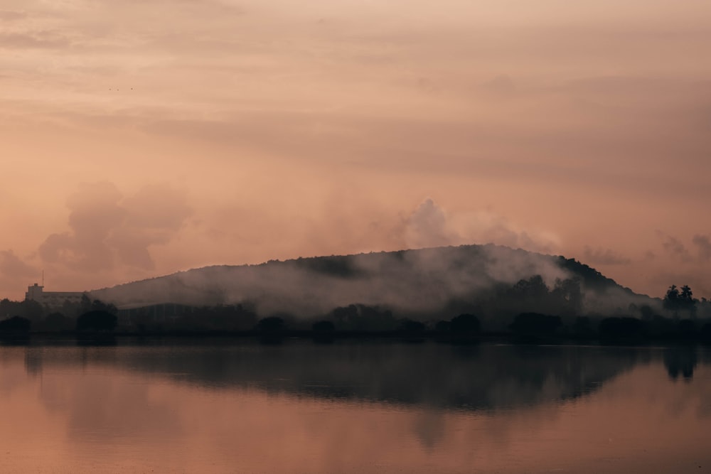 body of water near mountain during daytime