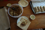Chef guiding a small group through the art of wrapping Thai spring rolls.