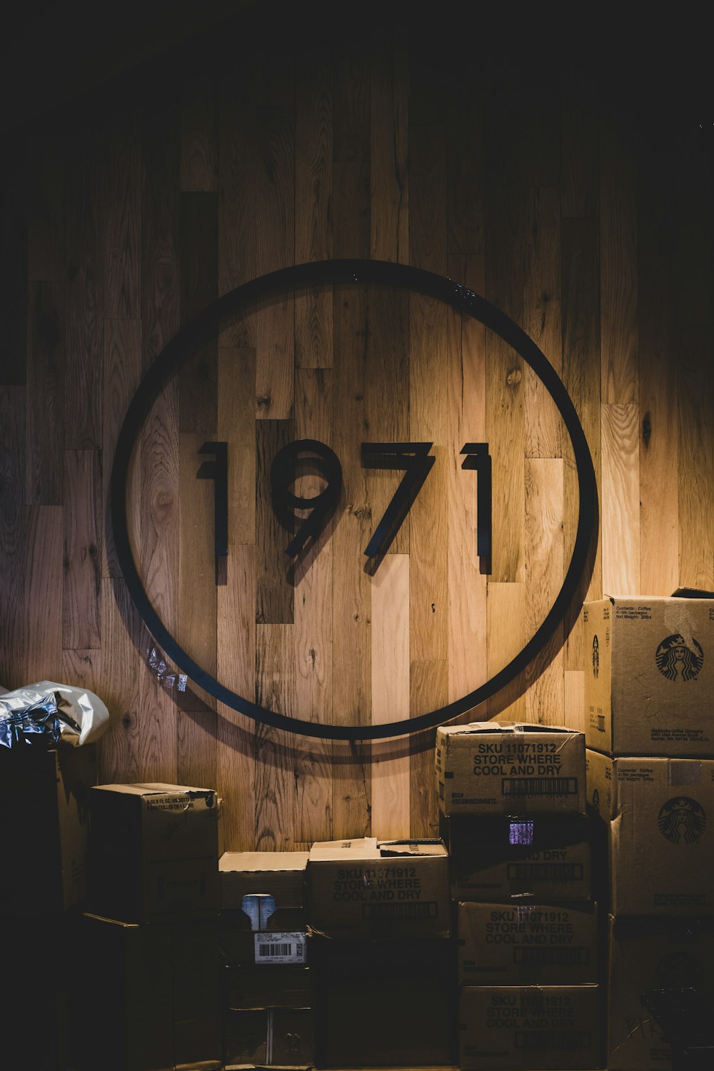 brown cardboard boxes beside brown wooden round frame