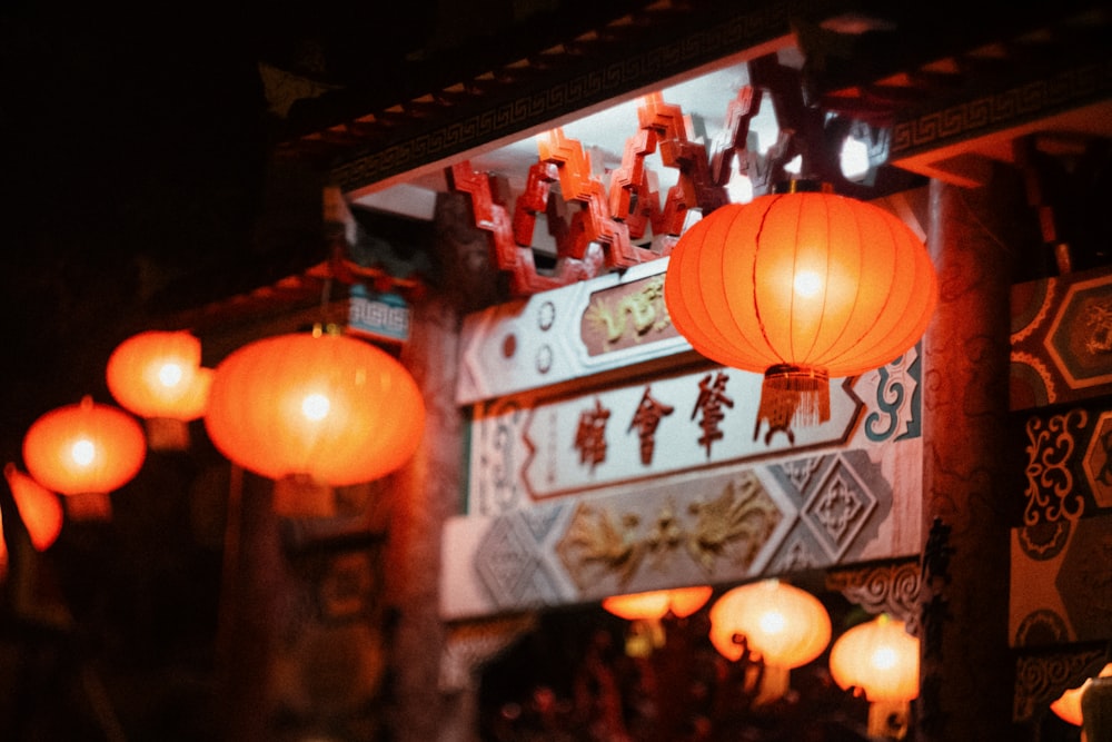 orange paper lanterns on street during nighttime