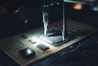 Close-up of a technician assembling a precision electronic instrument in a clean lab environment.