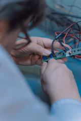 person holding blue and white plastic toy