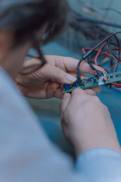 person holding blue and white plastic toy