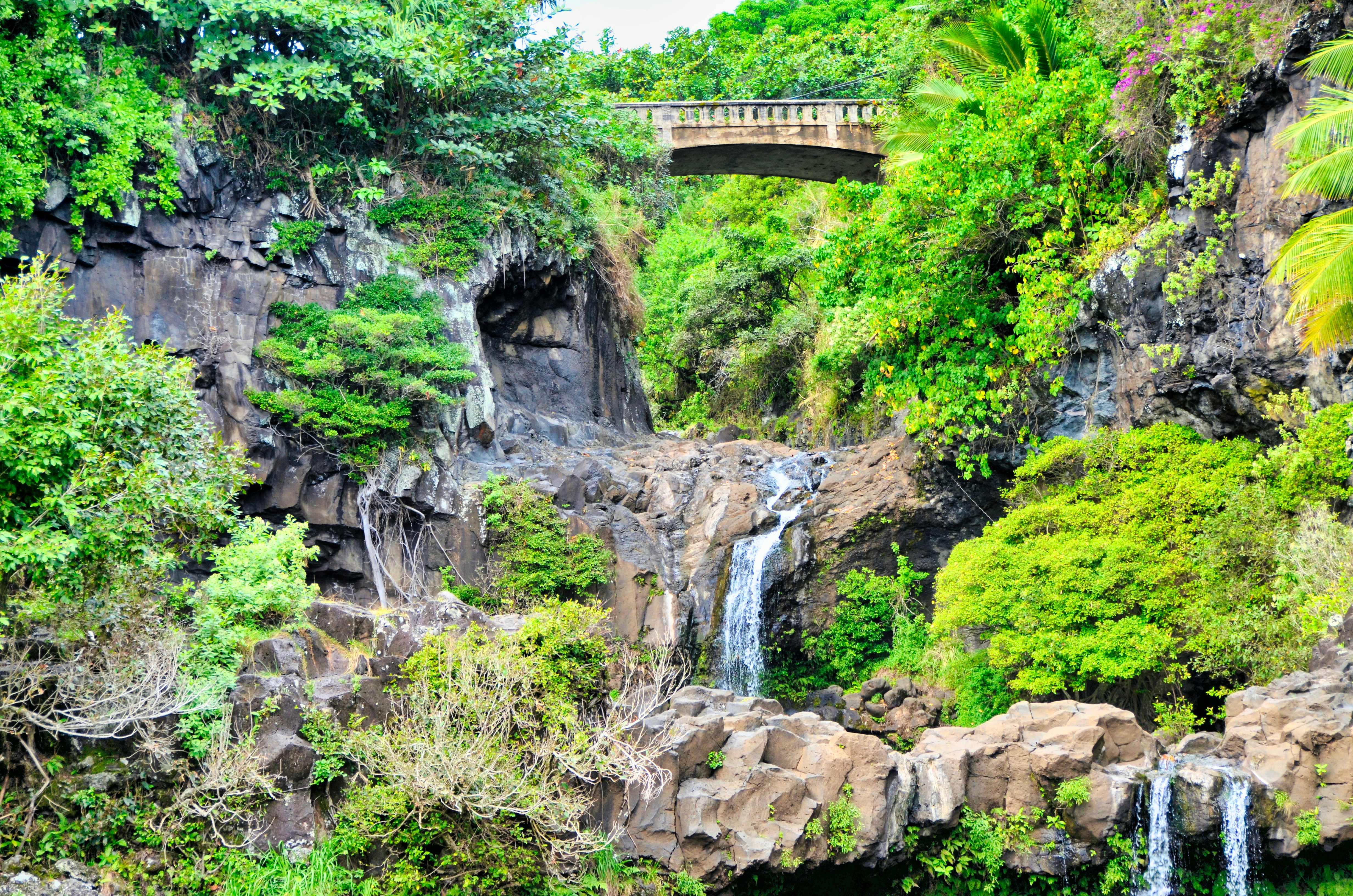 waterfalls on brown rocky mountain during daytime