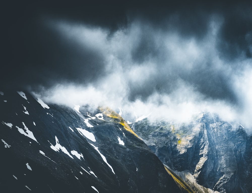 snow covered mountain under cloudy sky during daytime