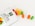 orange and green candies on white ceramic bowl