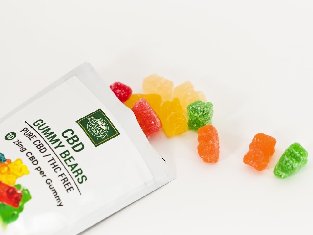 orange and green candies on white ceramic bowl