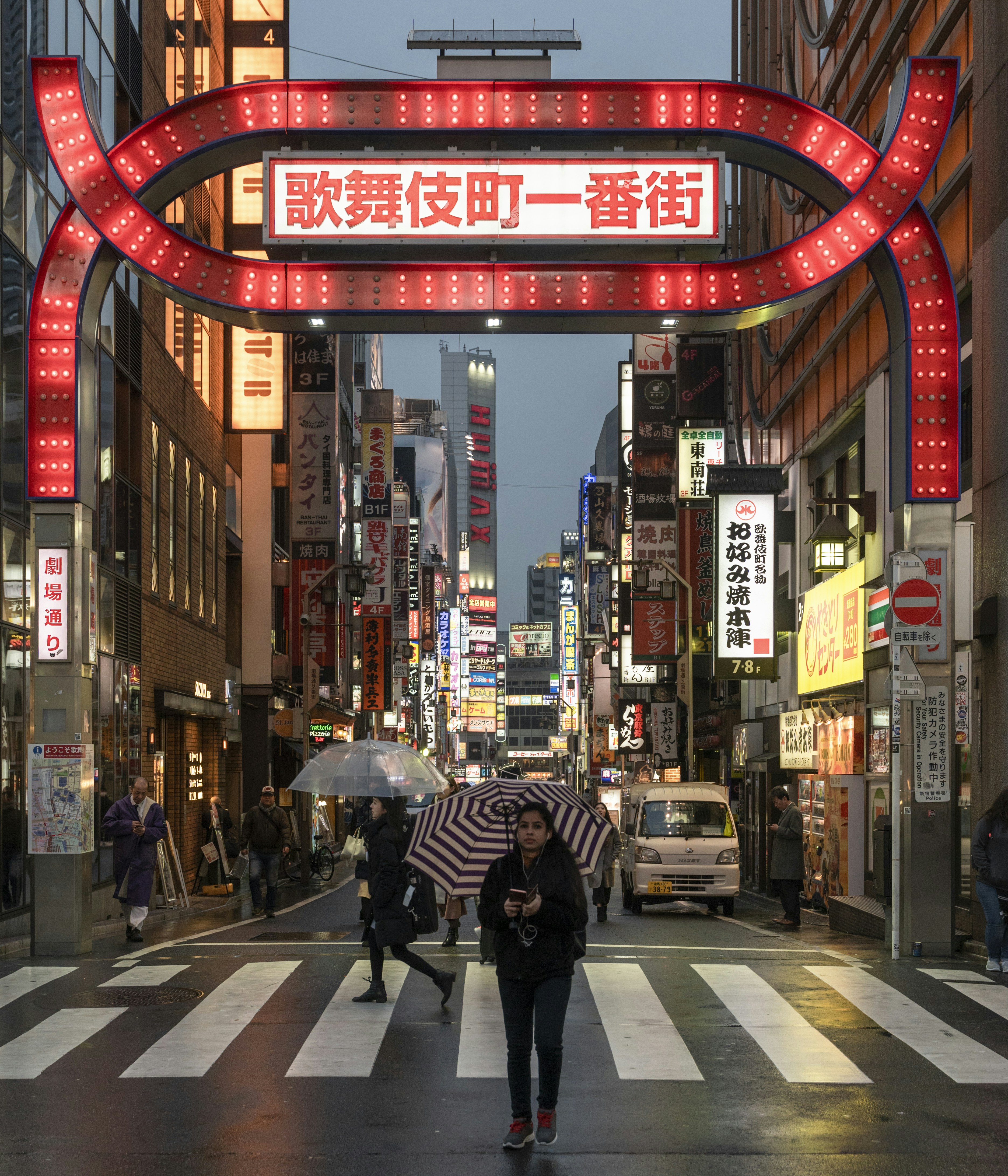 people walking on street during night time