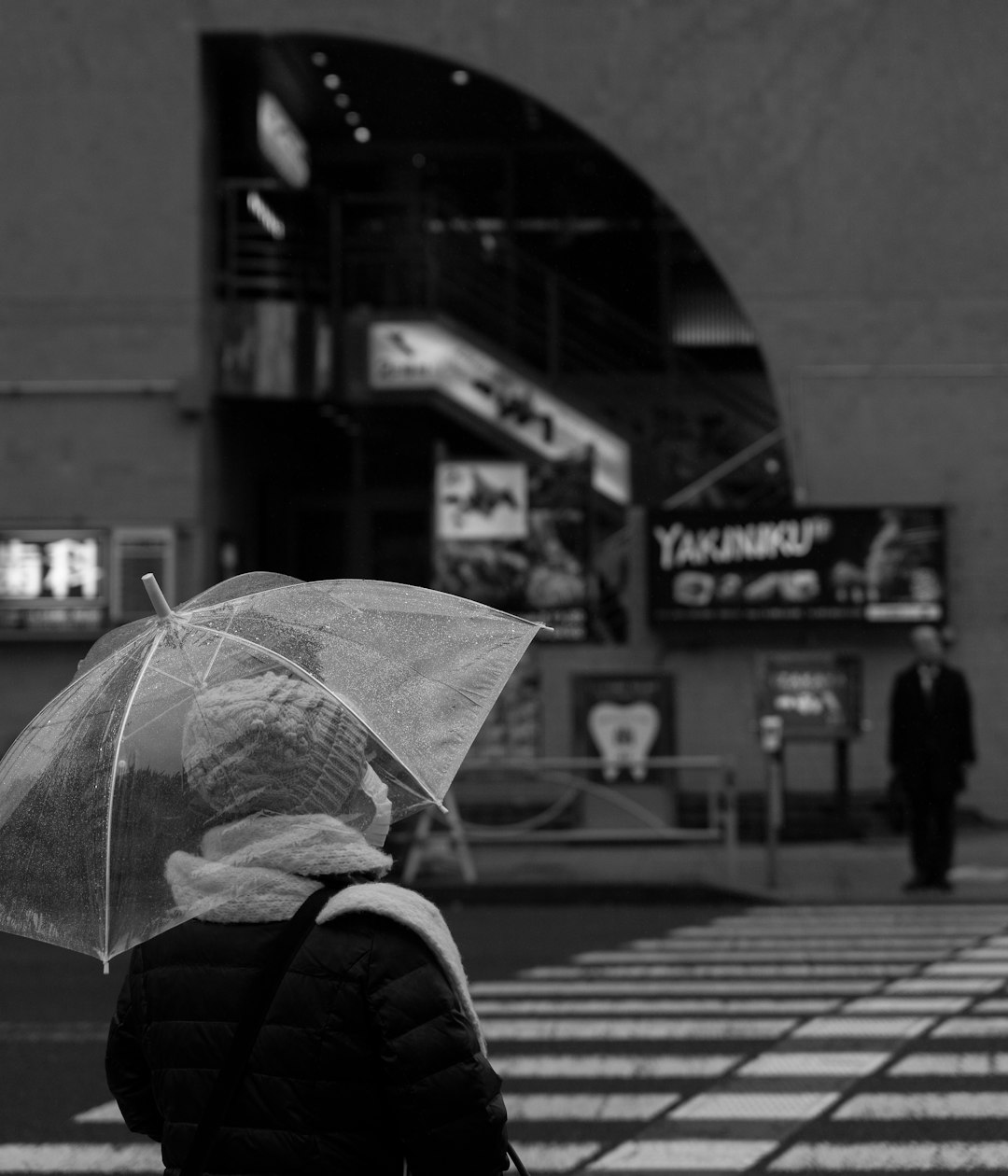 grayscale photo of person holding umbrella