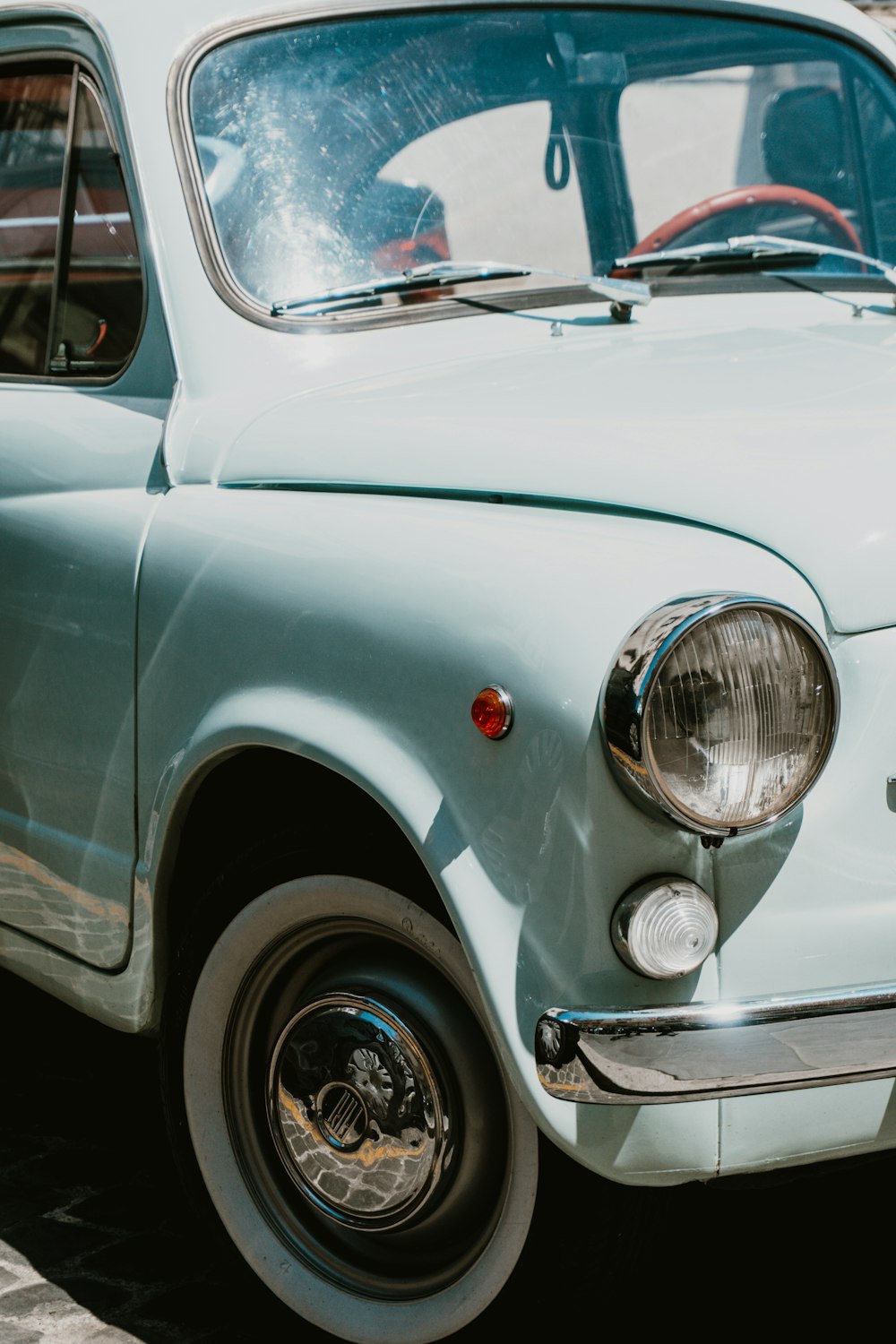 white classic car on gray asphalt road during daytime