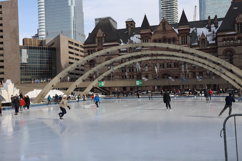 people walking on ice skating rink during daytime