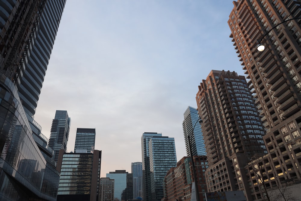 high rise buildings under white clouds during daytime