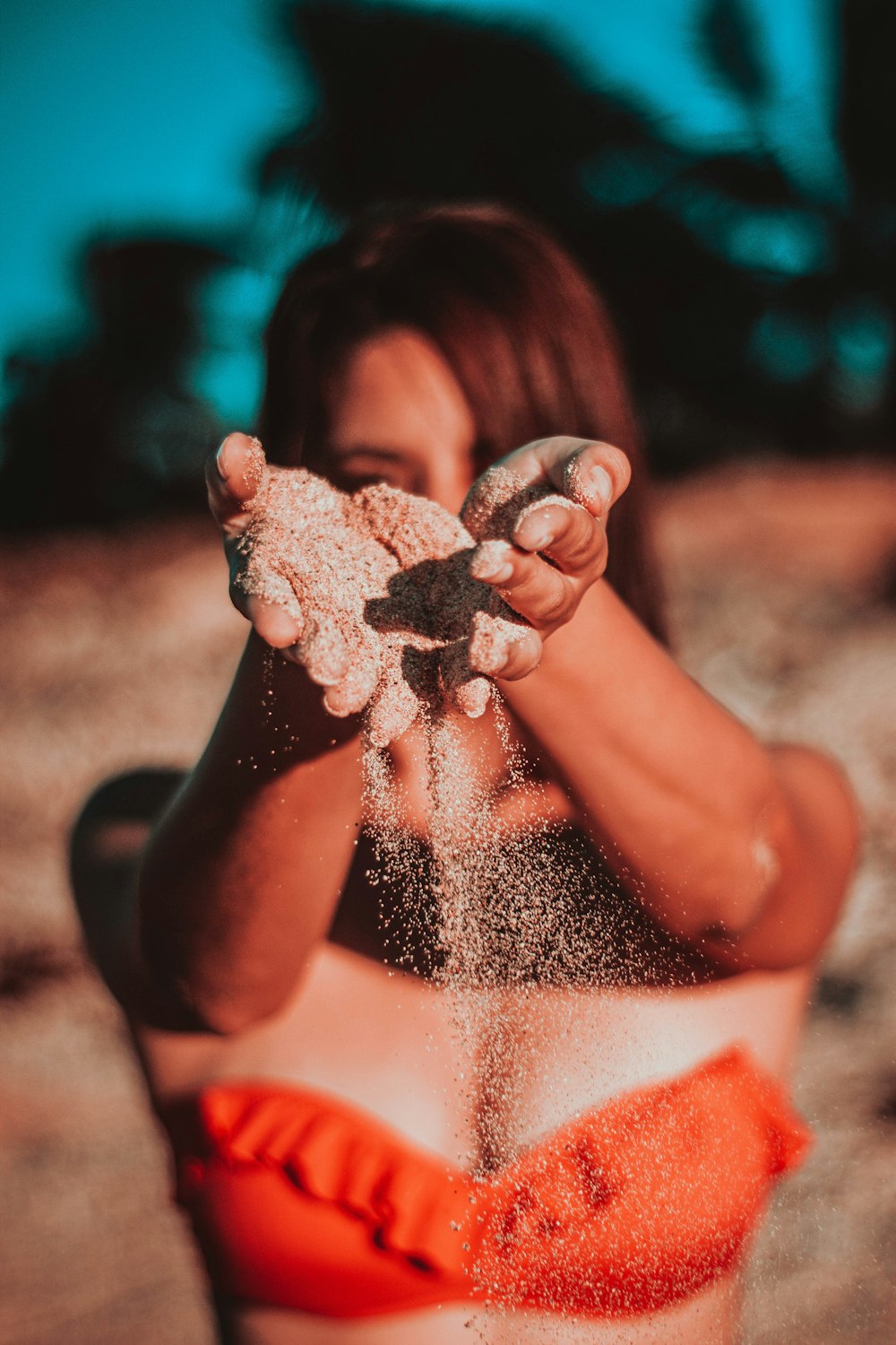 woman with sand on her hands