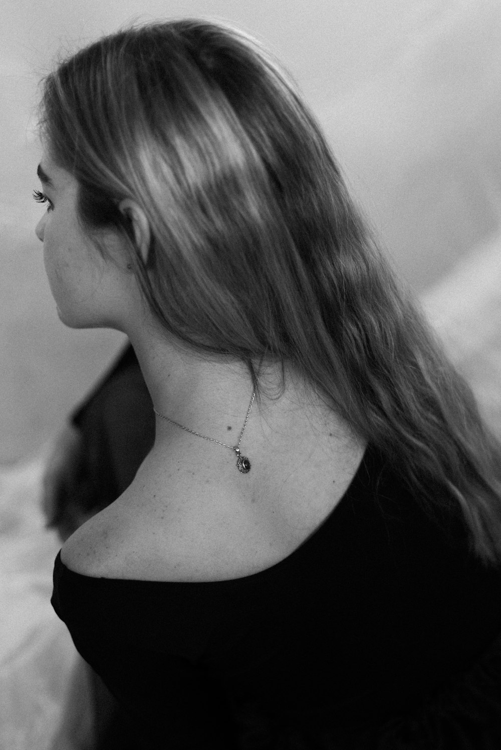 woman in black tank top wearing silver necklace