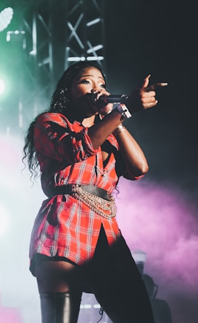 woman in red and white plaid dress singing
