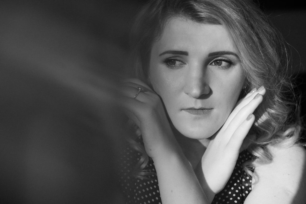 grayscale photo of woman in polka dot shirt