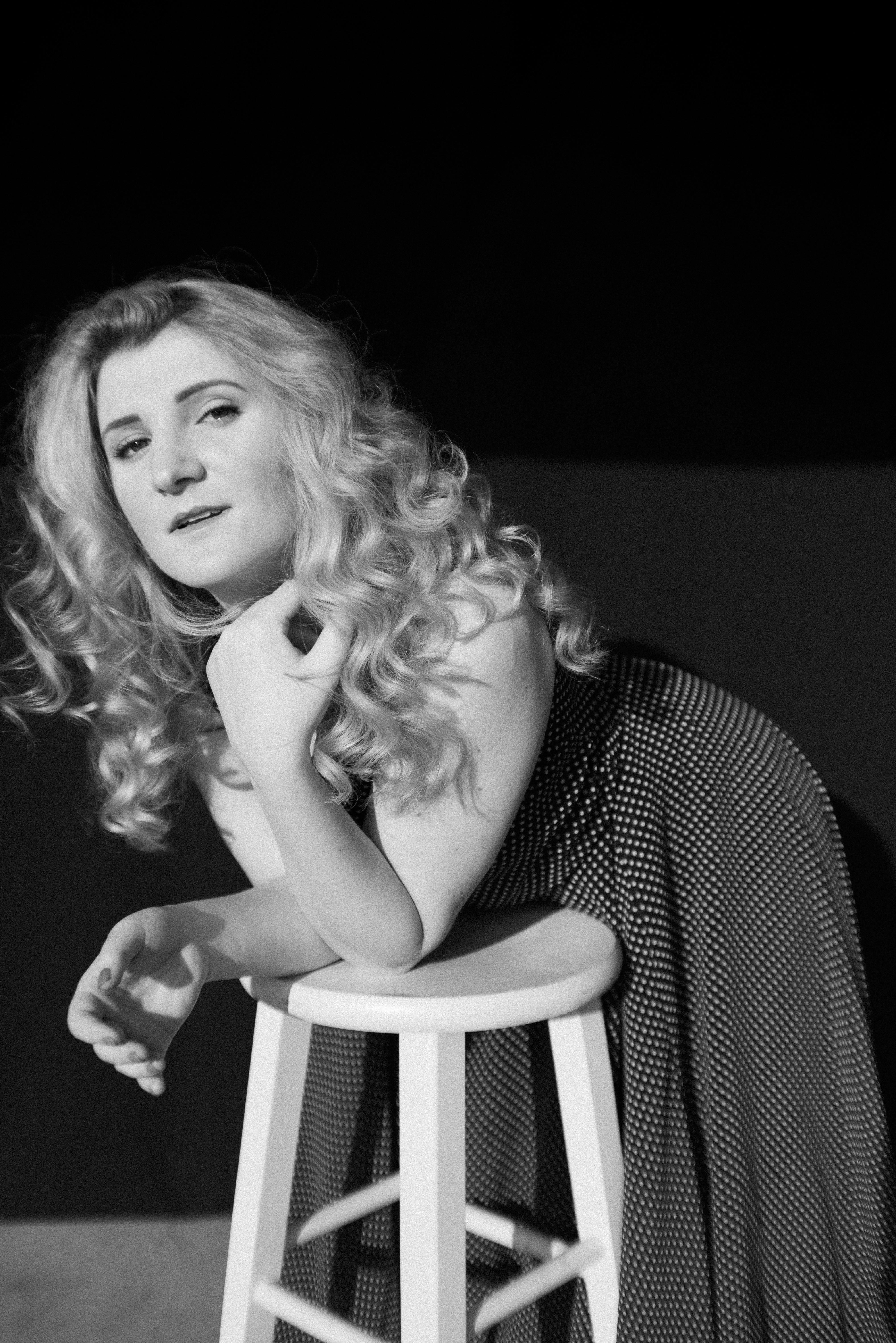 Woman In Black And White Stripe Long Sleeve Shirt Sitting On White