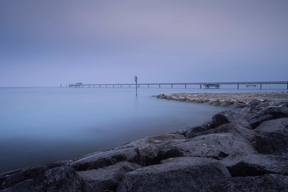 gray concrete dock on body of water during daytime