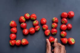 red strawberries on persons feet