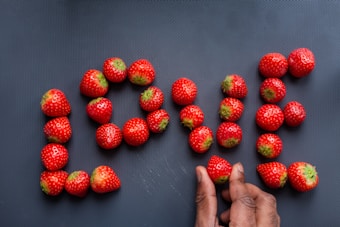 red strawberries on persons feet