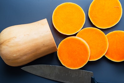 sliced orange fruit on white tissue paper yam teams background