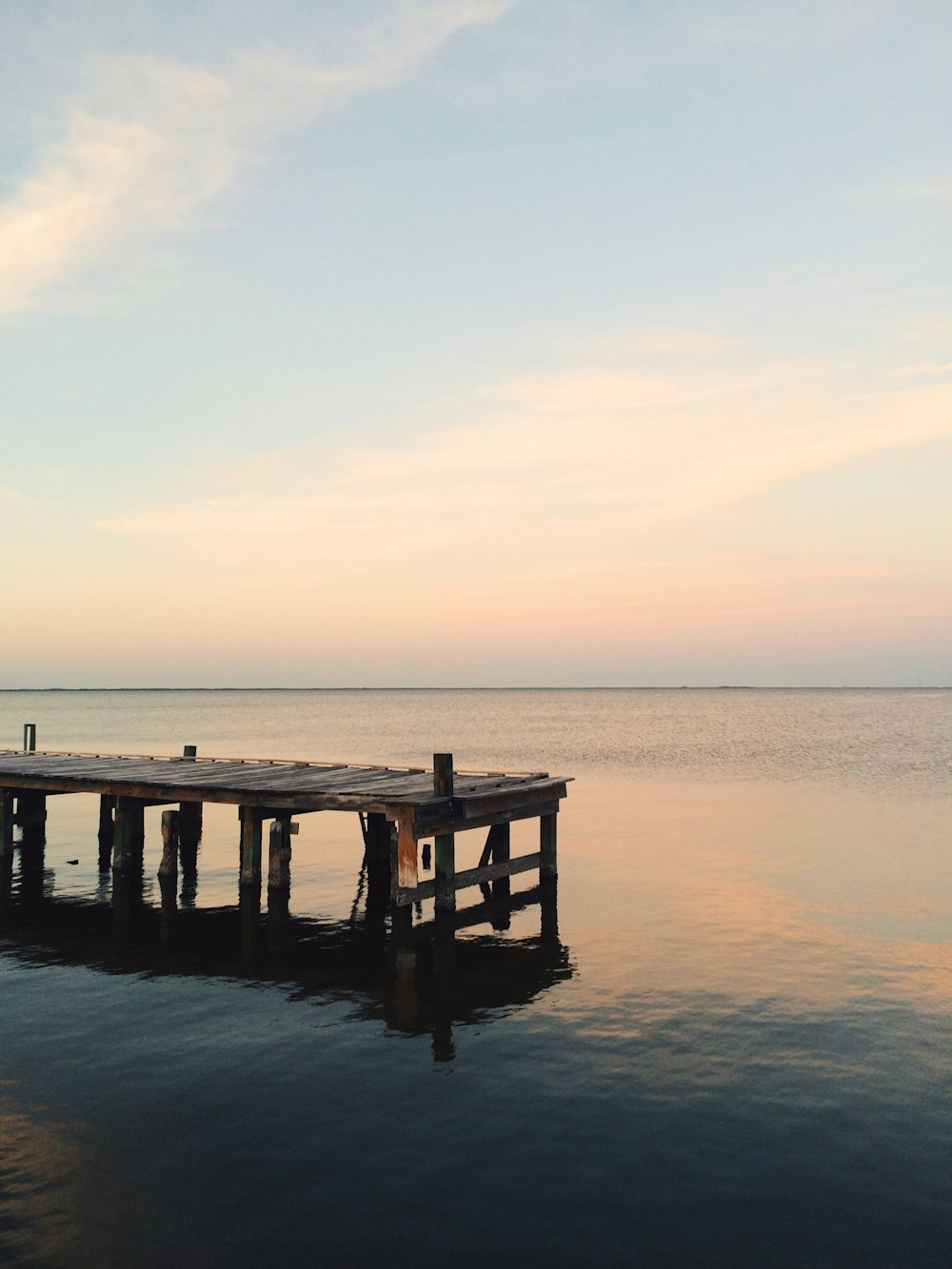 brown wooden dock on sea during daytime