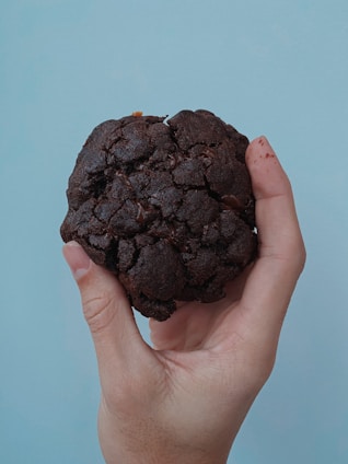 person holding a brown round ornament