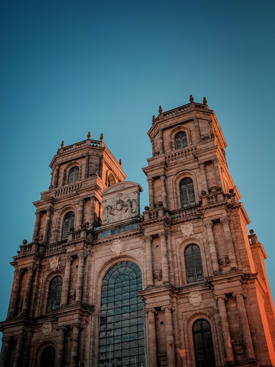 brown concrete church under blue sky during daytime in Cathedral Saint-Pierre de Rennes France