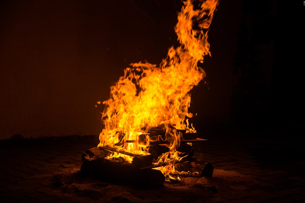 fire on black round fire pit during night time