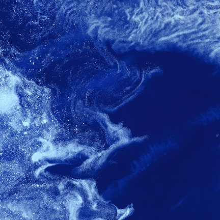 Abstract cosmic texture with subtle mineral grains in deep galactic blue.