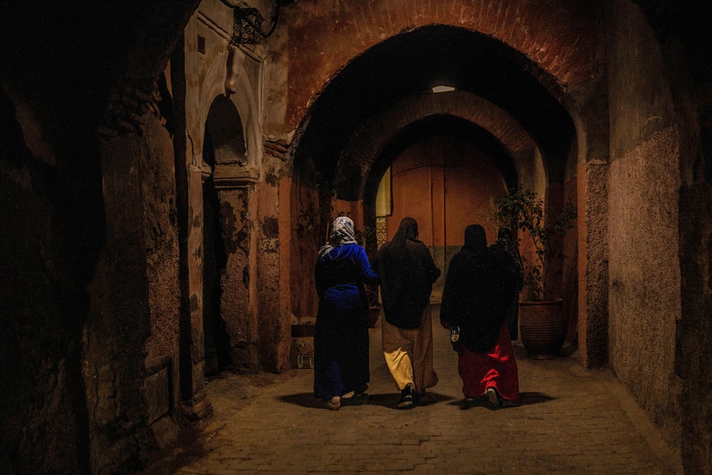 2 person in black and yellow robe standing in tunnel