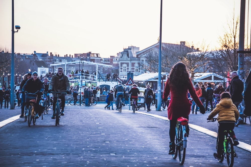 people riding bicycle on street during daytime