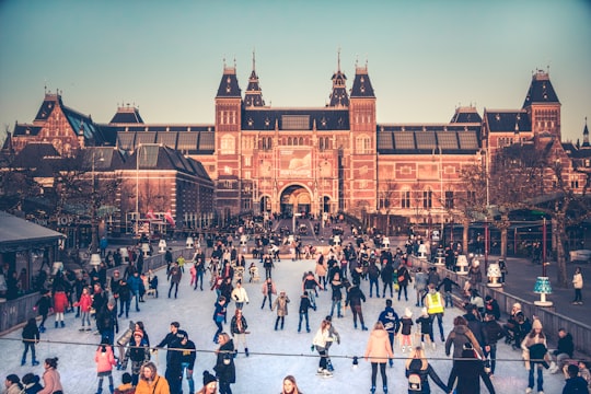 people in front of brown building during daytime in Rijksmuseum Netherlands