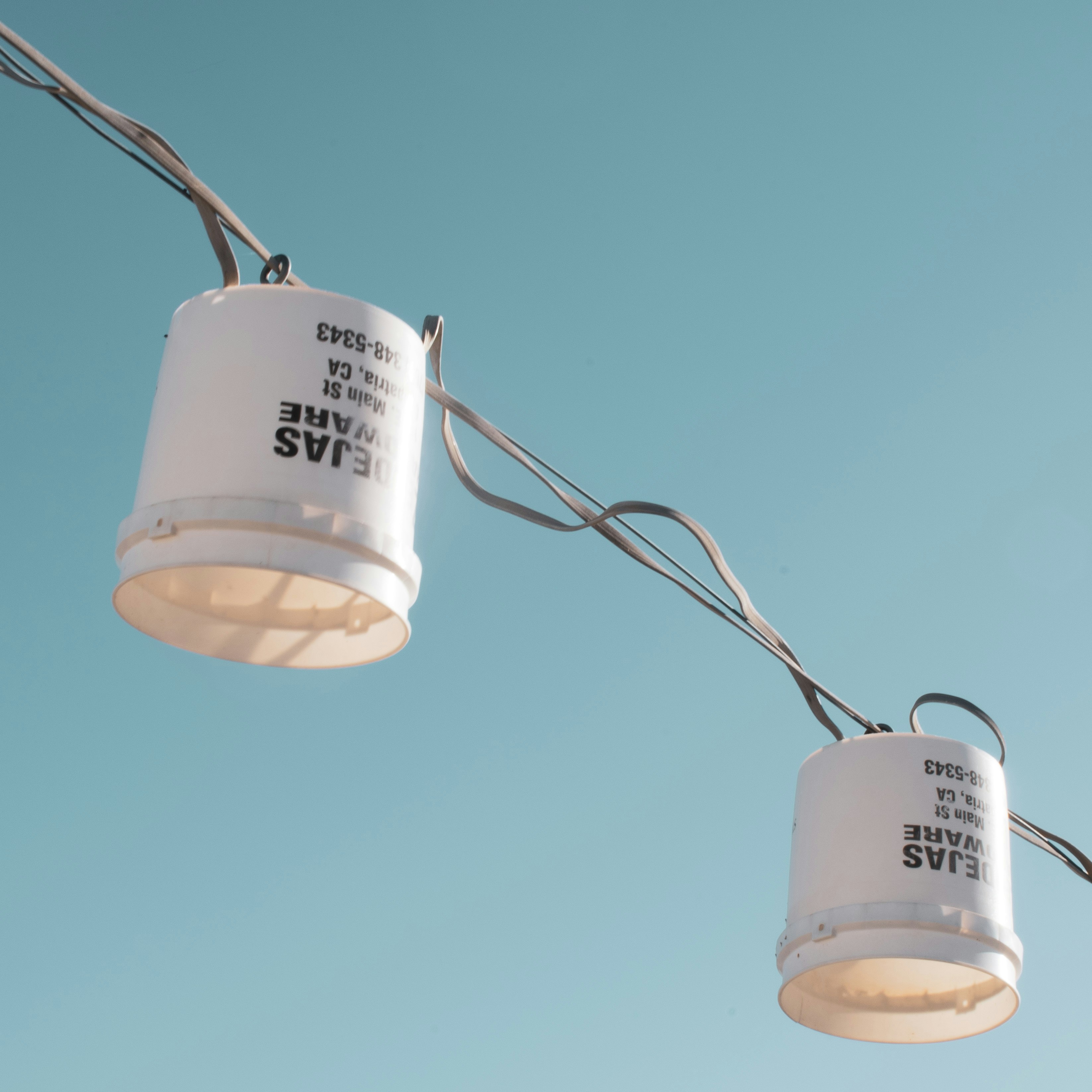 white and black ceramic mug on gray wire
