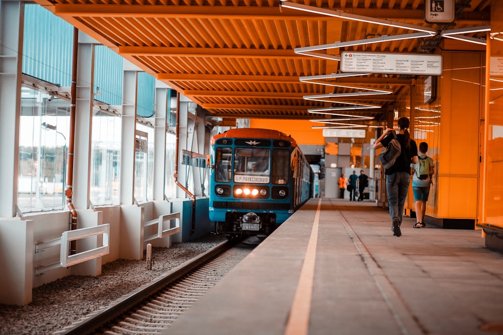 people walking on train station during daytime