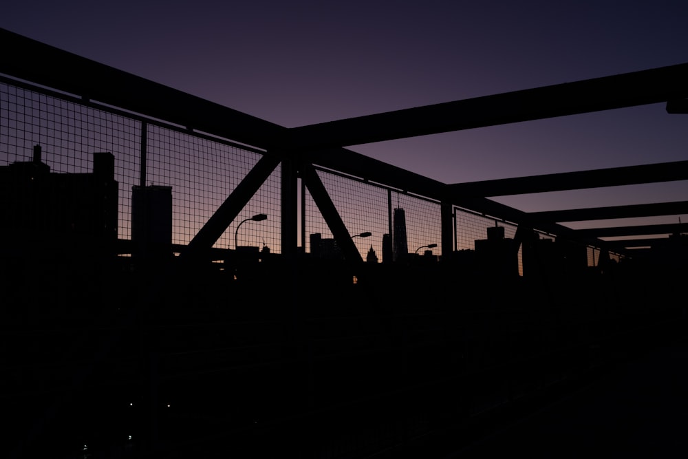 silhouette of people walking on bridge during night time