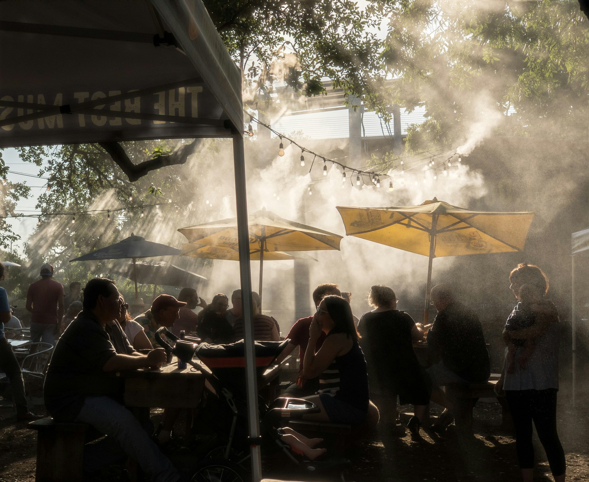 people sitting on chair under white canopy tent during daytime