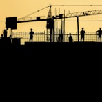 silhouette of people standing on tower crane during night time