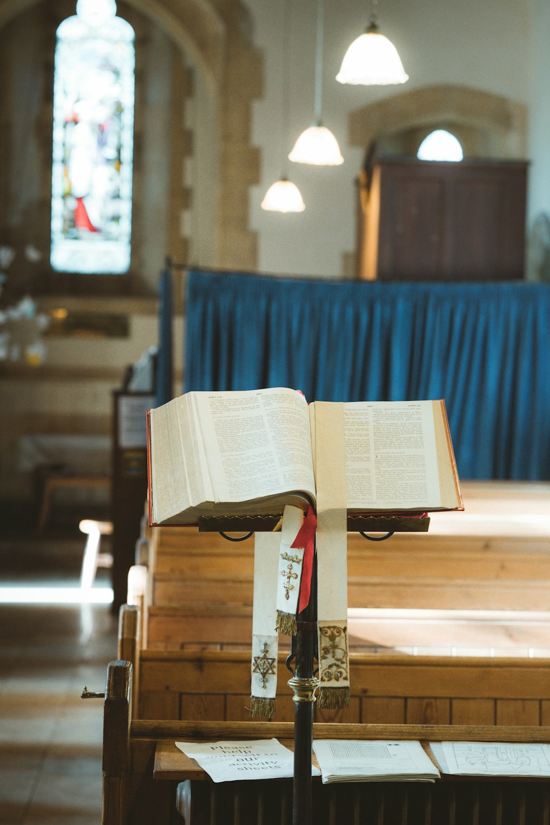 opened book on brown wooden bench