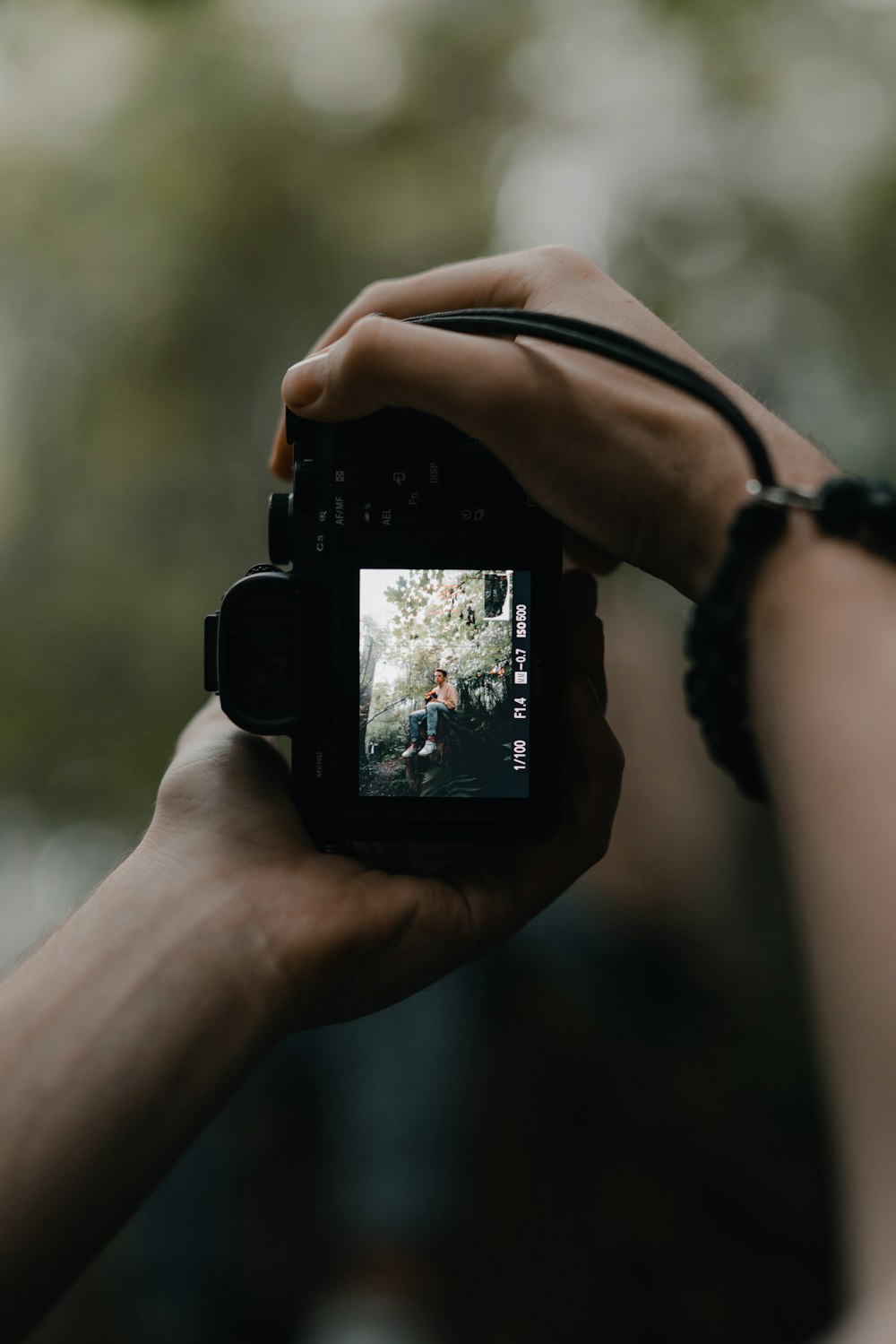 person holding black dslr camera