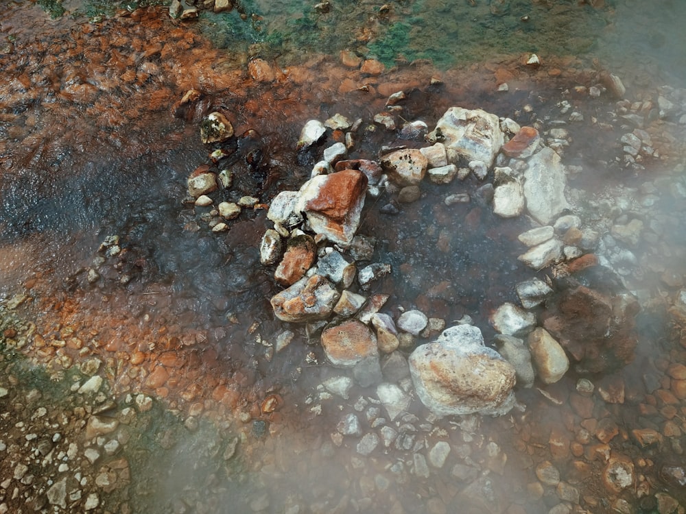 brown and gray stones on body of water