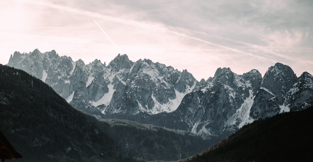 snow covered mountain under cloudy sky during daytime