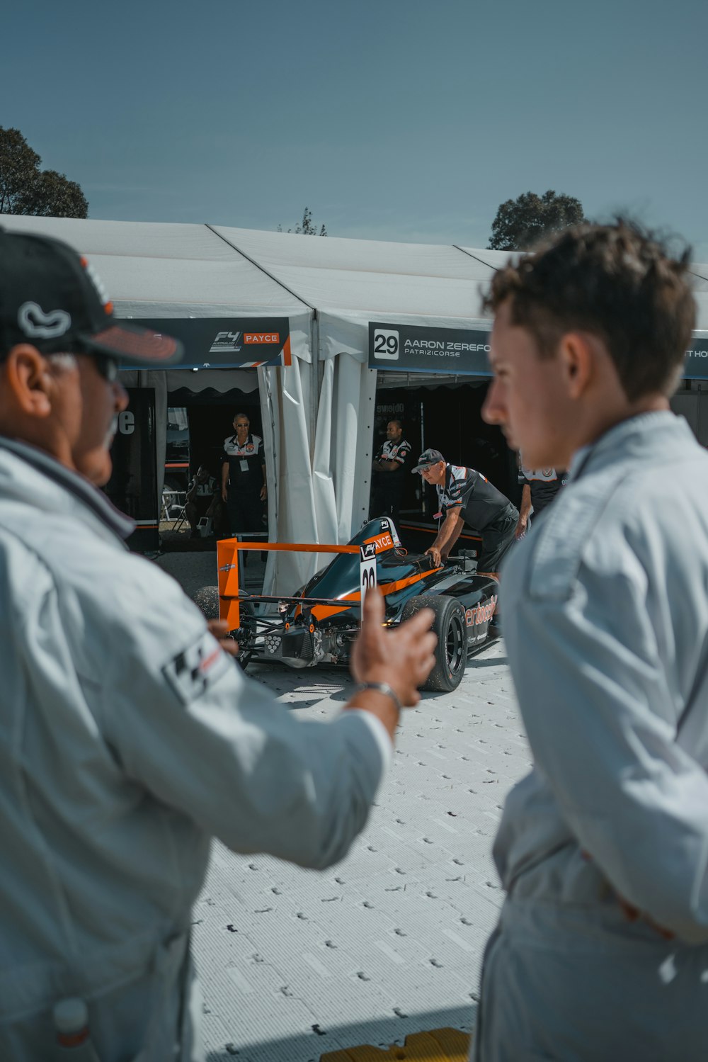 man in white dress shirt playing with orange and black toy gun