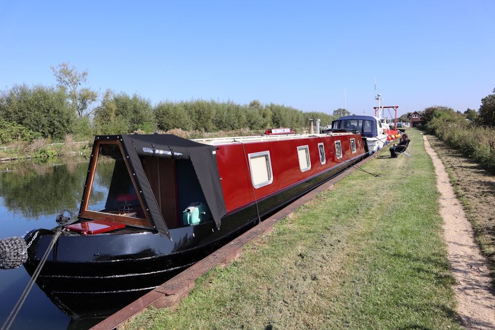 red and blue boat on green grass field during daytime